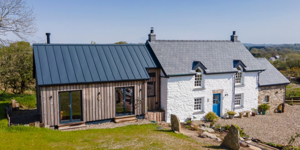 Welsh extension to existing stone cottage and new build using Vertix EasySeam Roof System